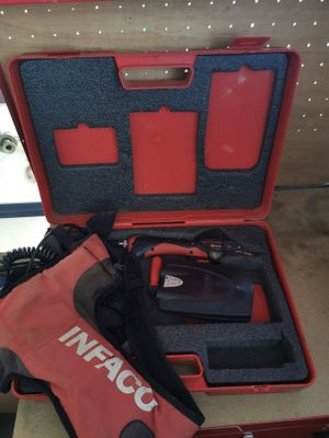 a red tool in a red case on a table