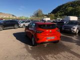 a red car parked in a parking lot next to other cars