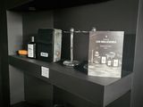 a black shelf with a box of perfumes on top of it