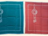 two tea towels with embroidered designs on them on a white background