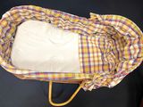 a basket with a blanket inside of it on a table