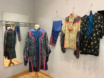 une exposition de vêtements asiatiques suspendus à un mur
