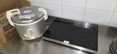 a stove top with a pot on it and a box on the counter