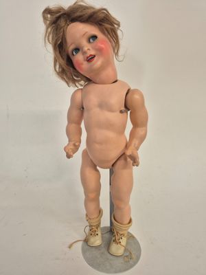 a small doll that is standing on a table