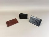 three different types of wallets on a white surface