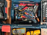 many different tools in a blue case on the floor