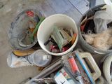 several buckets filled with assorted items sitting on the floor
