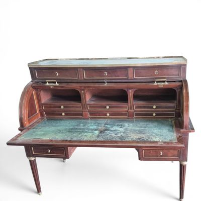 a wooden desk with a marble top and drawers