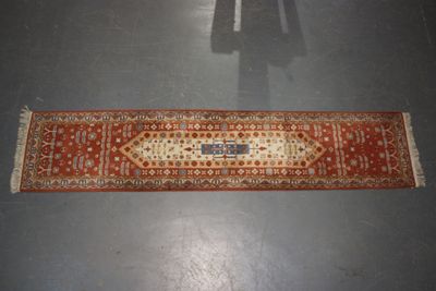 a long rug on the floor with a shadow of a person