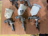 many different types of spray guns on a table