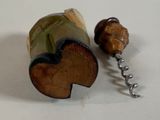 a bottle opener with a wooden handle and a cork stopper