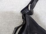 a black purse with a zipper on the inside of it