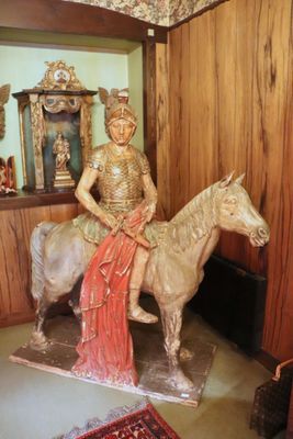 a statue of a woman riding a horse in a room