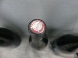 a bottle of wine sitting next to a pair of shoes
