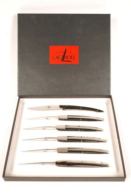 four different types of knives in a box on a white surface