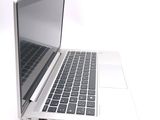 a laptop computer that is sitting on a white surface