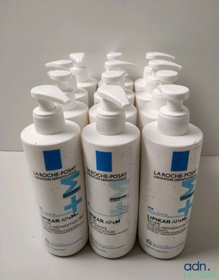 four bottles of lotion lotion sitting on top of a table