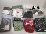 many different types of clothing in bags on the table