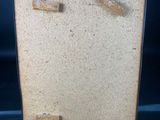 a small easel with a piece of wood on top of it
