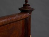 a close up of a bed with a wooden headboard