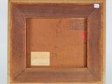 an old picture frame with a red tag on it and a white background