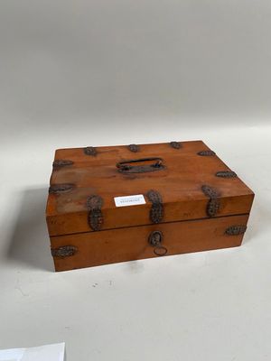 a small wooden box sitting on a white surface