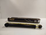 a close up of a black and yellow pen on a white surface