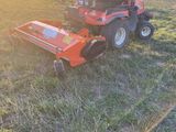a lawn mower sitting in the middle of a field