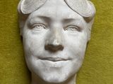 une sculpture blanche représentant un homme avec des lunettes de protection sur la tête