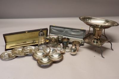 a silver plate and silverware on a white table