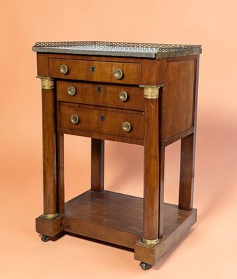 an old wooden table with two drawers and a marble top