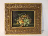 une photo d'un tableau de fleurs dans un cadre doré