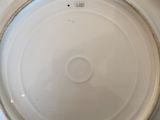 a white plate with a gold rim sitting on a table
