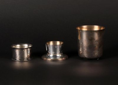 three silver cups sitting next to each other on a table