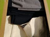 a cardboard box with a bunch of clothes inside of it