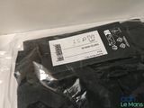 a bag of black clothing sitting on top of a table