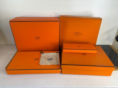 three orange boxes are stacked on top of each other on a table