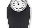 a black and white bathroom scale with a clock on it