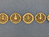 a row of gold plated bracelets on a blue surface