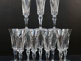 six clear wine glasses sitting on top of each other on a table