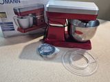 a red mixer on the counter next to a box of food