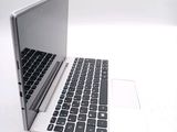 a white laptop with a black keyboard on a white surface
