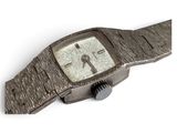 a watch that is sitting on a white surface