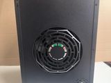 the back of a black computer case with a fan on top of it