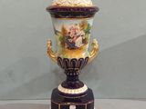 a vase that is sitting on a stand on a table