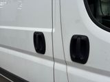 a white van that has two black handles on the side of it