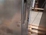 a stainless steel oven sitting on a pallet in the kitchen