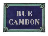 a blue and white sign that says rue cambon