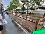 a man that is walking down the street in the rain