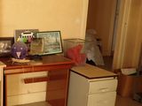 a desk with a computer on it in the corner of a room